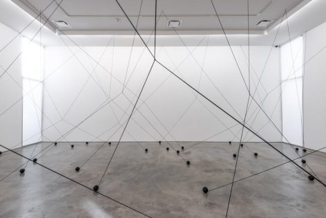 Magdalena Fern&aacute;ndez, 2i000.017, 2017. Iron spheres with black elastic cord, variable dimensions