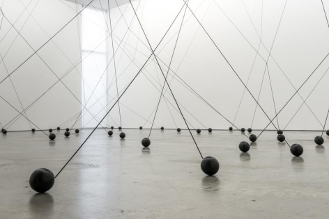 Magdalena Fern&aacute;ndez, 2i000.017, 2017. Iron spheres with black elastic cord, variable dimensions